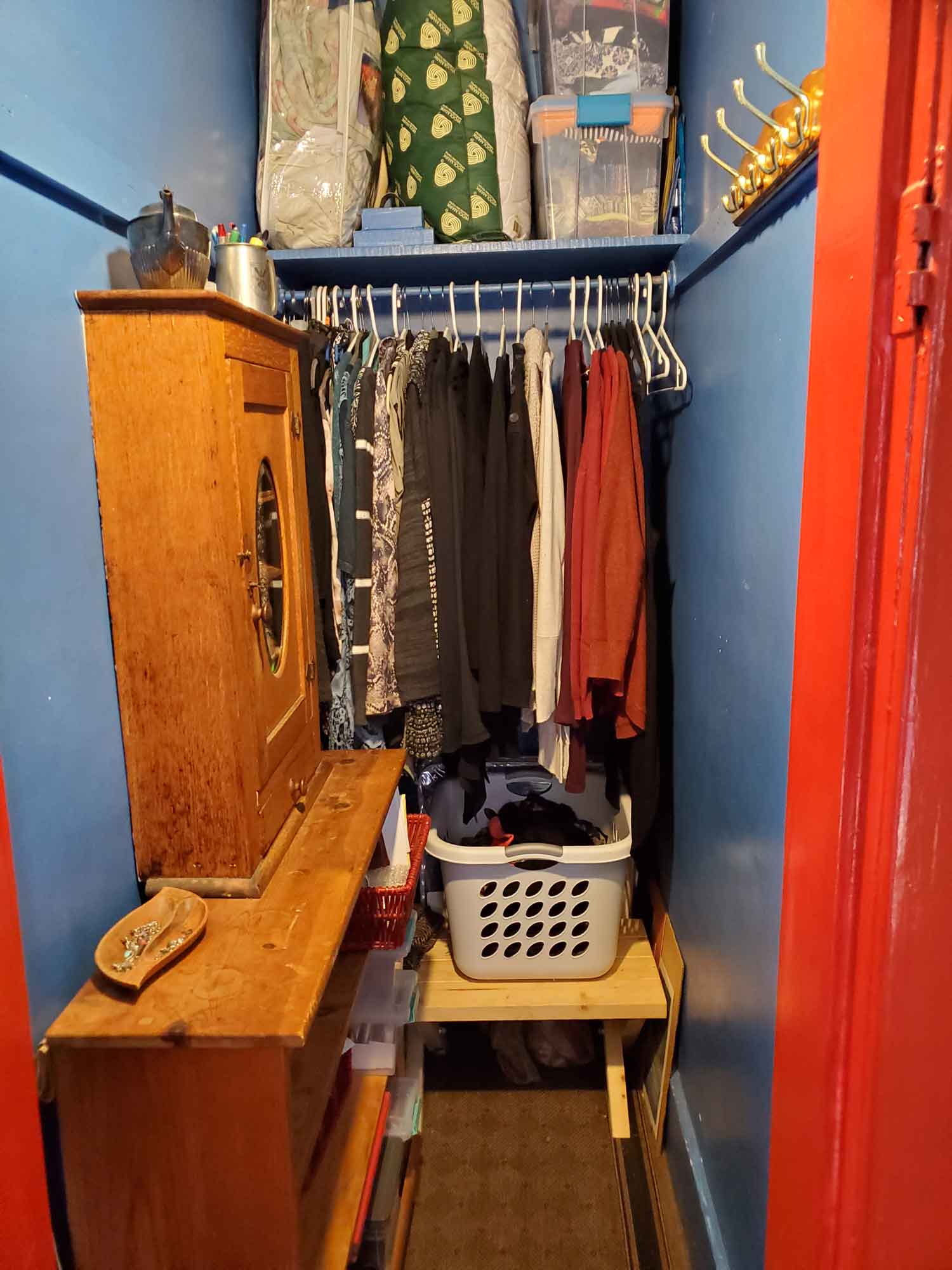 A better organized closet with shelving and cabinet added on the left