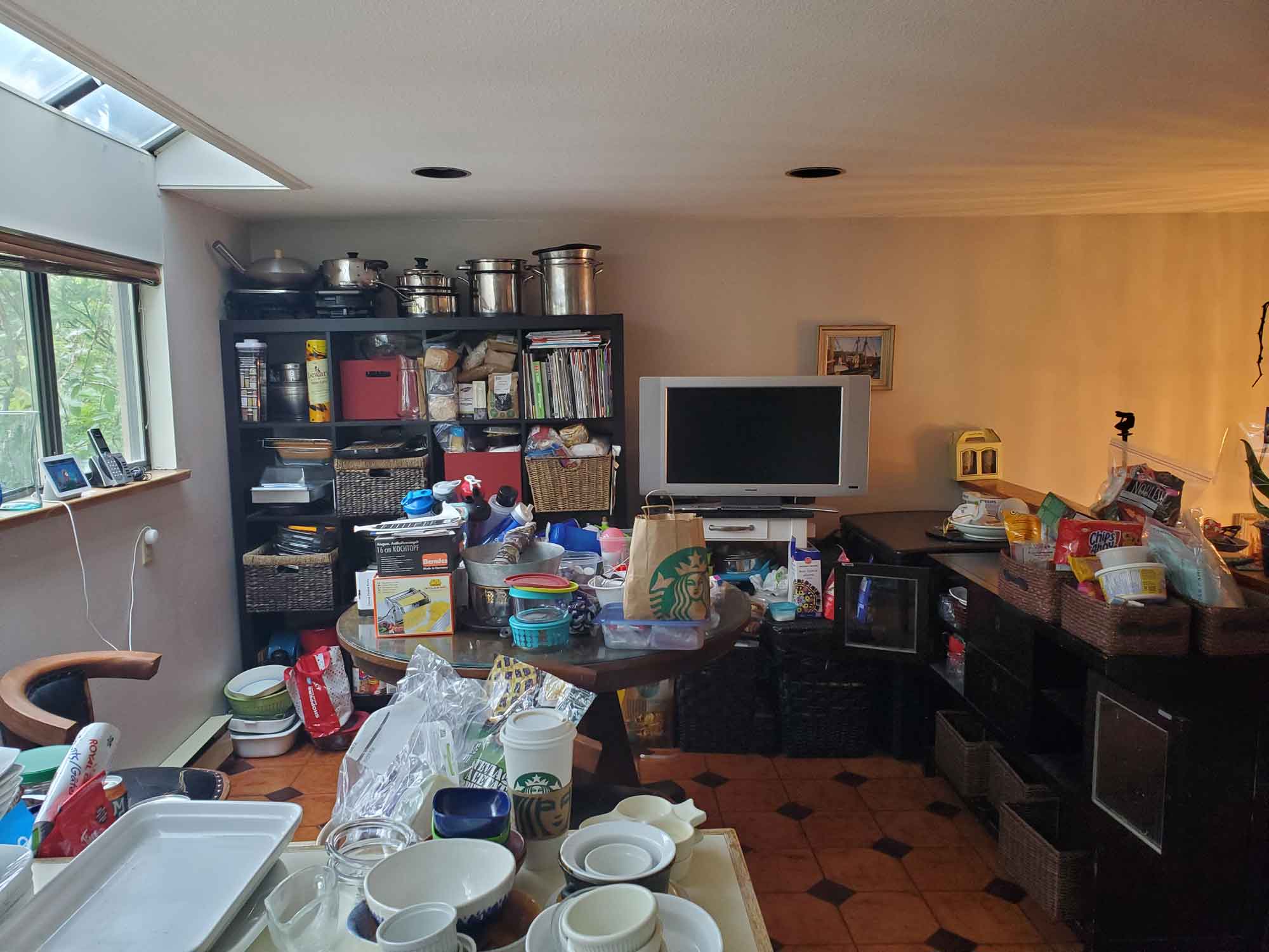 Kitchen table and counters full of items making them inaccessible